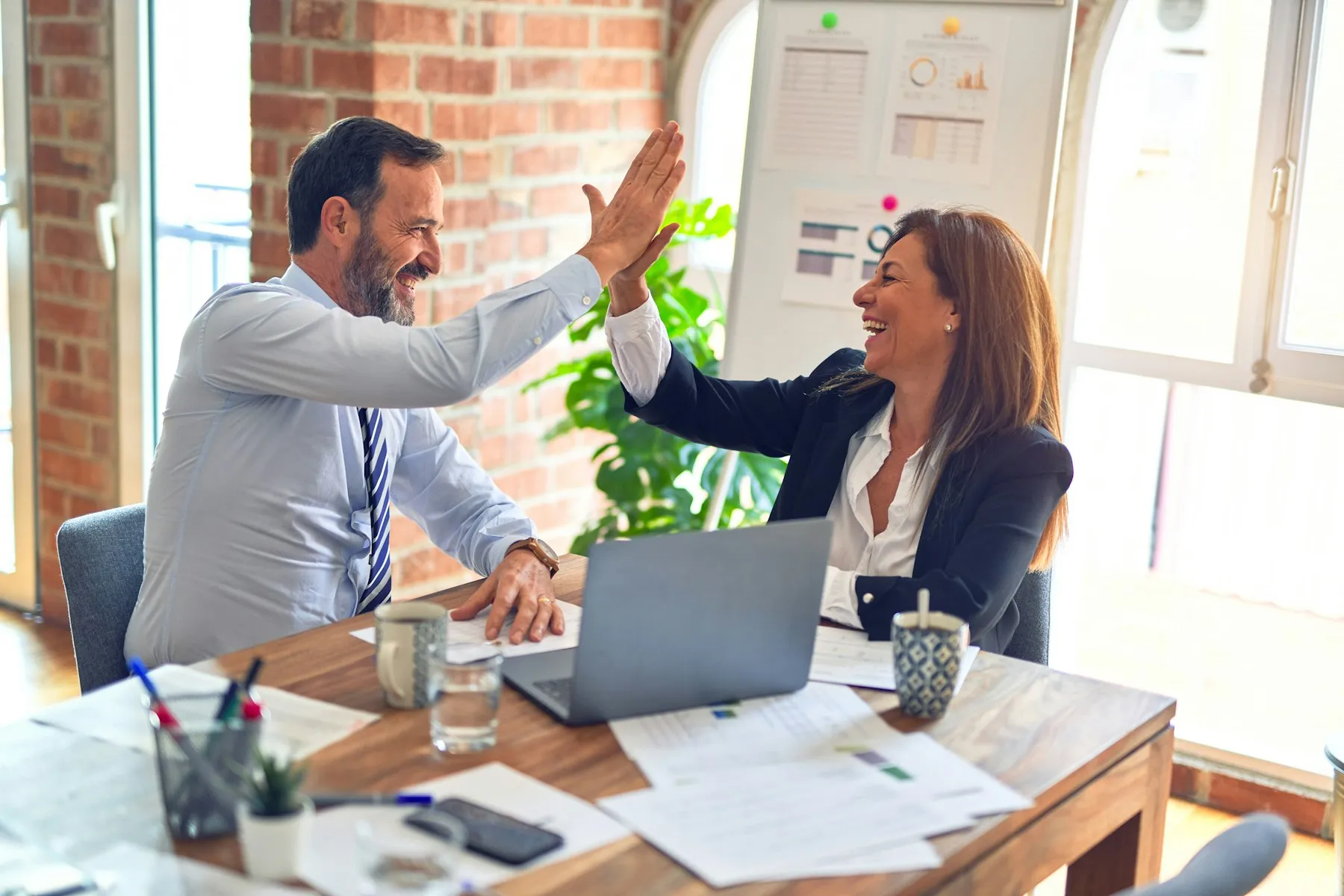 Small business owners reviewing a month of results